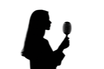 Silhouette of a person singing or speaking into a microphone