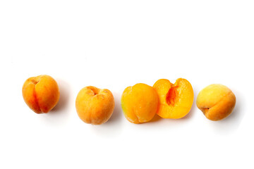 Fresh ripe apricots on a white background.