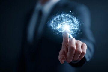 Business professional pointing at a glowing holographic brain, symbolizing AI, intelligence, and digital transformation.