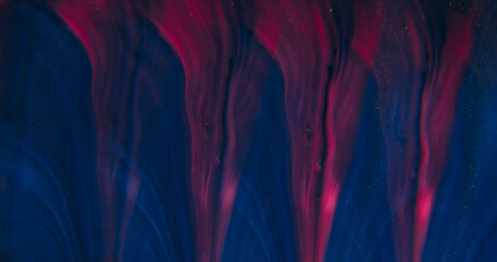 Paint spill. Neon background. Defocused purple pink blue colorful glitter flow particles spreading on creative acrylic abstraction.