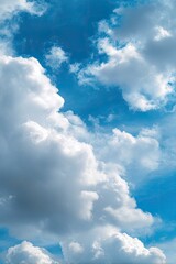 Vast, cumulus clouds against a vibrant blue sky