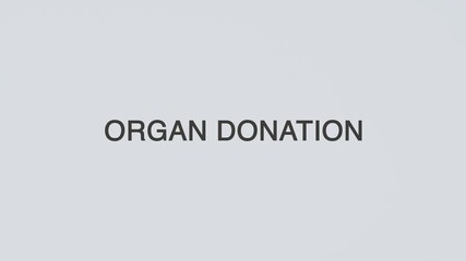 Organ Donation word diagnosed with hand holding stethoscope on white background, illustrating transplantation, healthcare support, medical ethics, and patient care