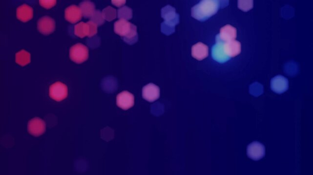 Out of focus hexagonal bokeh lights in pink and blue