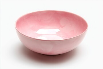 A pink ceramic bowl sits on a white surface reflecting light and casting a soft shadow