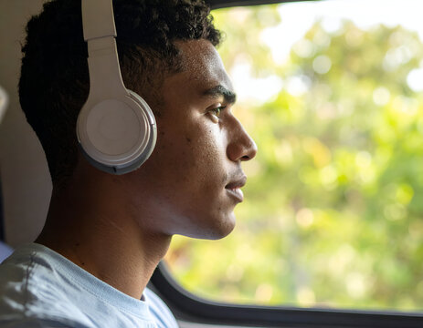 From a captivating profile angle, a Gen Z student with eyes intently focused is deeply immersed in a virtual class experience, embracing modern digital education.