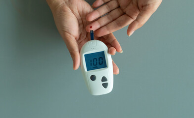hand of people check diabetes and high blood glucose monitor with digital pressure gauge. Healthcare and Medical concept	