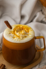 Autumn hygge Orange Cup of warm coffee autumn leaves on table against raindrops are running down the glass in window. Cozy fall still life footage burning candles. Thanksgiving and Halloween holiday