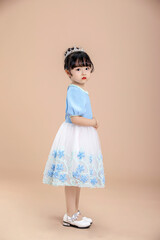 A little Asian girl in a blue dress