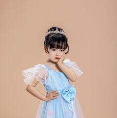 A little Asian girl in a blue dress