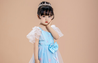 A little Asian girl in a blue dress