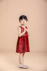 A little Asian girl in a red dress