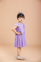 A little Asian girl in a purple dress