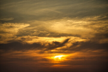Golden Sunset with Vibrant Sky and Dynamic Cloud Patterns