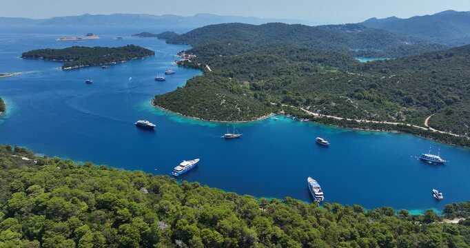 Luxury yachts anchored in a calm bay on the green island of Mljet, Croatia