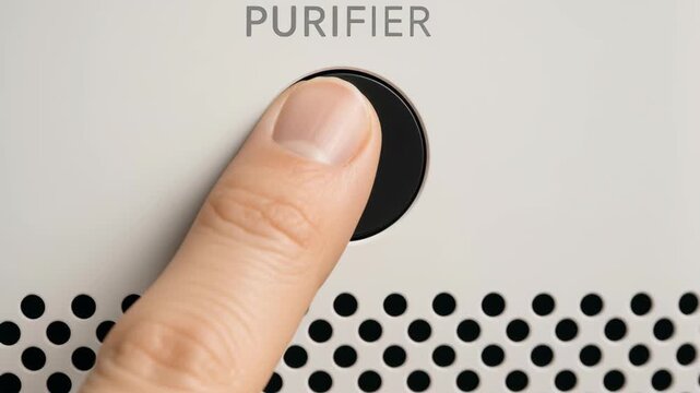 Finger pressing power button home purifier device improving water quality with white surface and perforated design for clean air