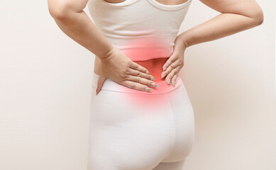 Woman with lower back pain holding waist