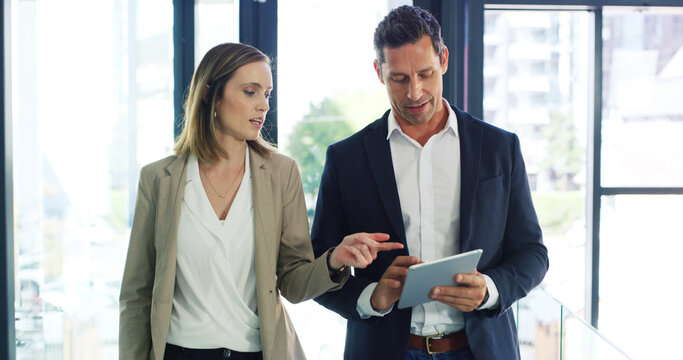 Businessman, woman and talk with tablet, review and discussion with risk management app at company. People, team and tech with perspective, feedback and point with collaboration at insurance agency