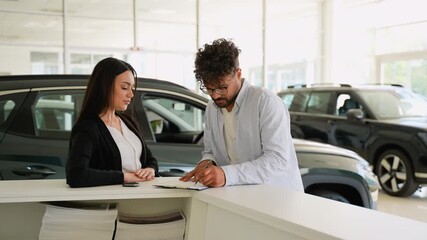 Car saleswoman giving keys to customer after signing contract - Powered by Adobe