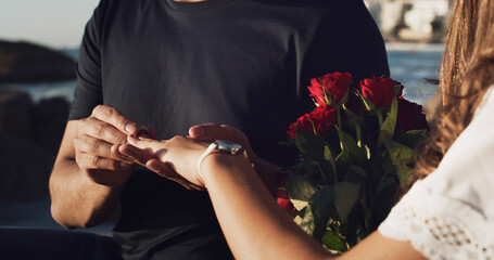 Engagement, love and hands of couple at beach for marriage proposal, romance and support. Wedding ring, roses and vow renewal on anniversary with man and woman for commitment and save the date