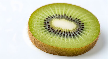 A vibrant close-up shot of a perfectly sliced kiwi fruit reveals its intricate inner patterns and textures against a pristine white backdrop, showcasing its freshness and appeal as a healthy snack