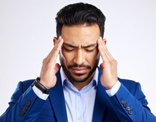 A frustrated businessman in a suit holds his head in his hand, expressing the stress and pain of a business problem