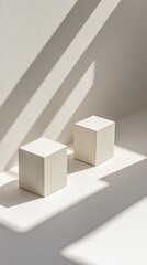 Fototapeta premium Two white cubes in a sunlit white space, casting sharp shadows creating a minimalist and geometric composition