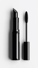 Obraz premium Close-up of black lipstick and mascara applicator against a white background