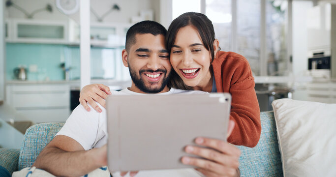 Tablet, smile and couple in living room for video call, communication and bonding on home sofa. Hug, technology and happy man with woman, website and social media or internet browsing for discussion - Powered by Adobe