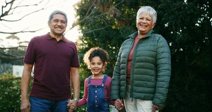 Grandparents, child and holding hands with portrait in garden for bonding together, support or love. Family, senior people and girl kid with smile outdoor for relationship, weekend visit and security
