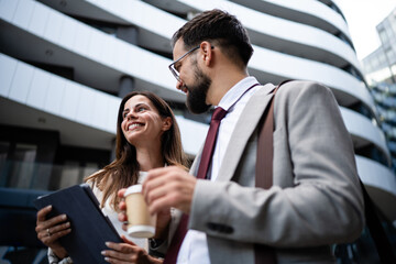 Business people walking and talking outside office building