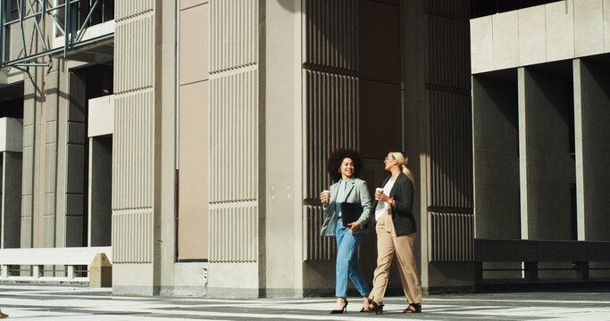 Commuting, employees and women with coffee, smile or travel to meeting for sales, laughing and walk. Outdoor, colleagues and salesperson with caffeine, collaboration and communication for project - Powered by Adobe