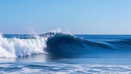Fototapeta premium Powerful Blue Ocean Wave Breaking Under Clear Sky