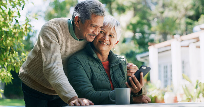 Backyard, happy and mature couple with phone for funny conversation, bonding and relax outdoor Retirement home, coffee and senior man and woman on smartphone for internet, connection and website