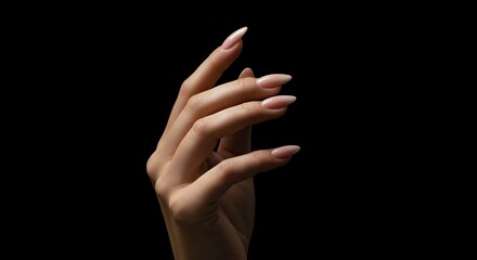 Woman's hand gesture against black background