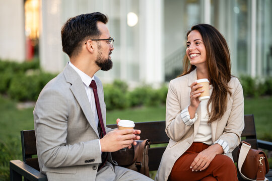 Business people chatting and drinking coffee outdoors during break - Powered by Adobe