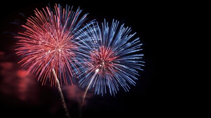 Red and blue fireworks explode in the night sky