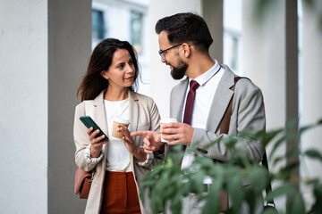 Business colleagues discussing work during coffee break
