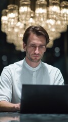 A contemplative Caucasian man in a luminous sphere of chandeliers, crafting digital dreams, echoes of Diwali and Techsgiving