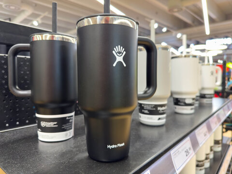 Villach, Austria - August 18, 2025: Hydro Flask insulated tumbler with straw displayed on retail shelf, showcasing sleek design and modern branding for hydration enthusiasts
