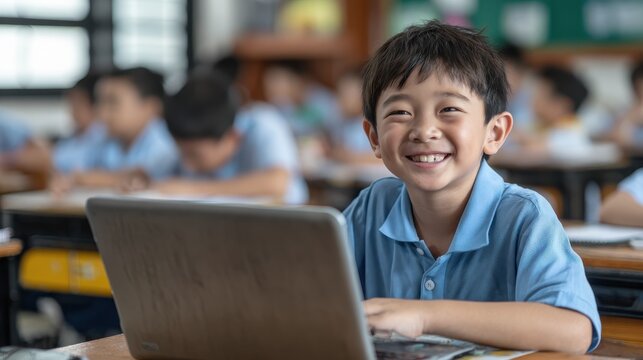 happy smiling asian school boy using laptop computer at class in classroom smiling chinese junior school student learning online virtual education digital program app technology during tech lesson no