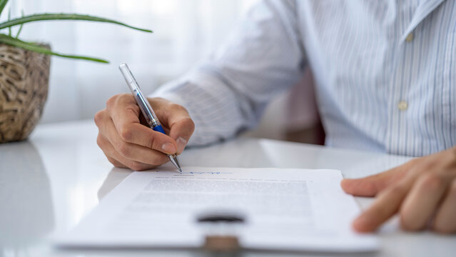 Businessman signing a contract. Car rental contract, house sale contract.