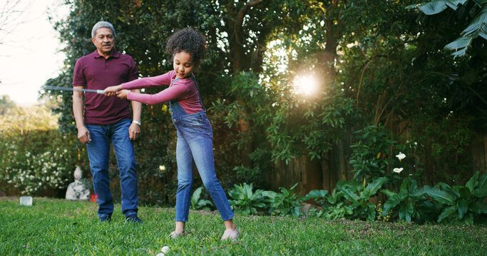 Grandfather, child and playing golf outdoor for hobby, learning skills and teaching technique. Family, senior man and girl kid with sports in garden for bonding together, swing practice and weekend