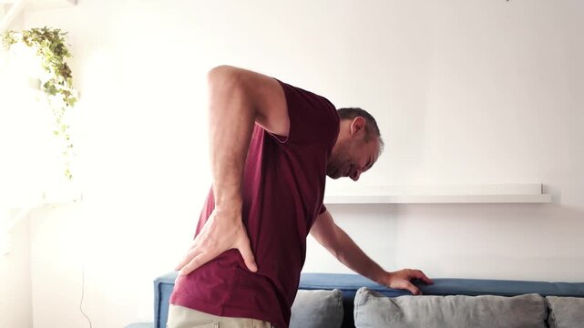Man with hip, back and sciatica pain at home.