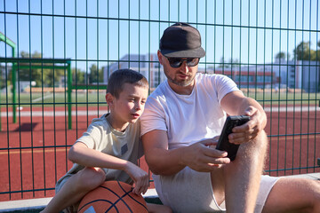 Father and a son playing basketball