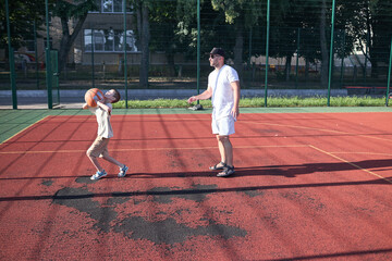 Naklejka premium Father and a son playing basketball