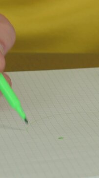 Creating detailed notes and sketches with a green highlighter in a notebook