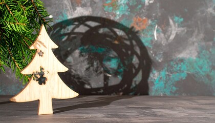 Wooden christmas tree ornament on a dark surface.