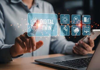 Person interacting with digital twin interface on laptop with icons and smartphone in hand near desk