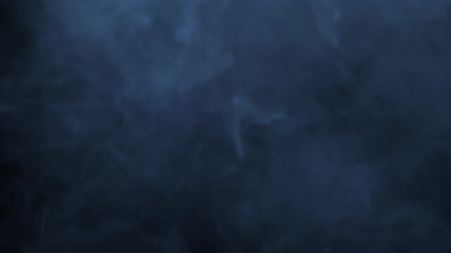 Bluish smoke drifting across dark background. Cool misty overlay effect for atmospheric video compositions and moody visual projects.