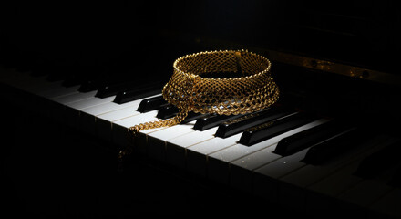 Golden necklace on piano keys